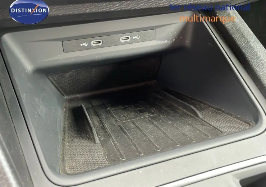 Espace de rangement central avec deux ports USB-C dans l'habitacle d'une SEAT LEON ST gris urbain 2023.