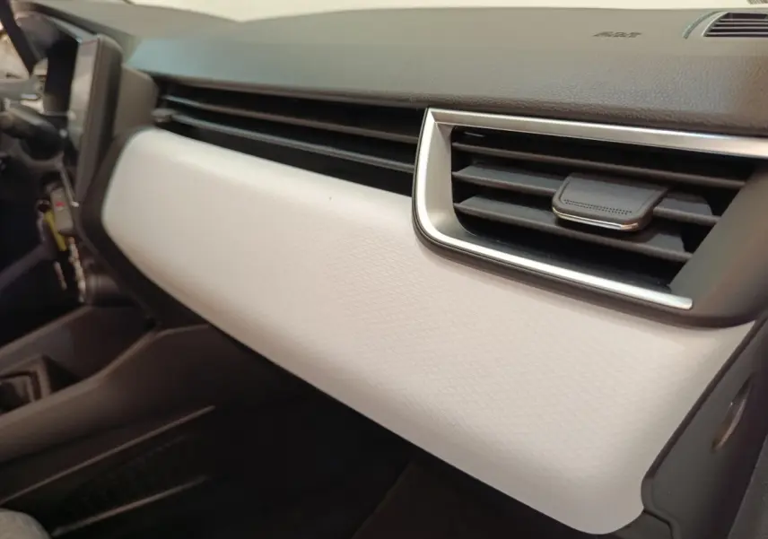 Détail de la planche de bord blanche et noire de la Renault Clio Evolution TCe 100 GPL 2023, côté passager.