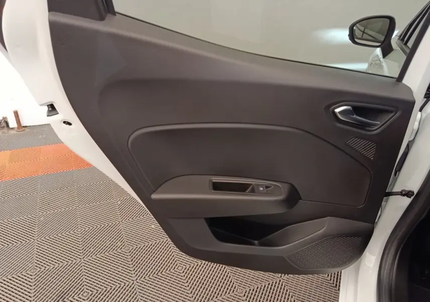Vue intérieure de la porte arrière droite noire d'une Renault Clio blanche Evolution TCe 100 GPL 2023.