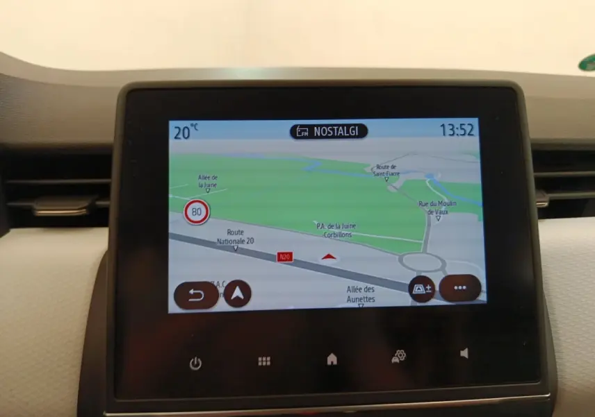 Écran tactile central affichant la navigation 3D dans l'habitacle clair d'une Renault Clio blanche.