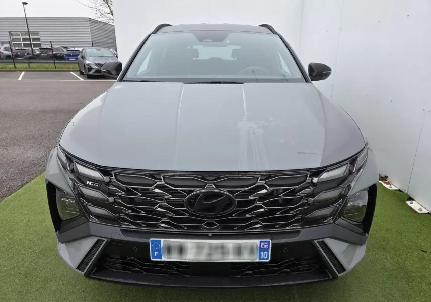 Vue frontale du Hyundai Tucson 2025 gris Shadow Grey avec calandre noire N Line et détails chromés.