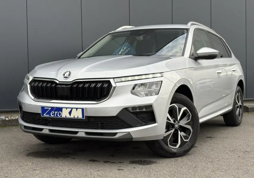 Vue 3/4 avant droite d'un Skoda Kamiq gris argent avec calandre noire et jantes alliage distinctives.