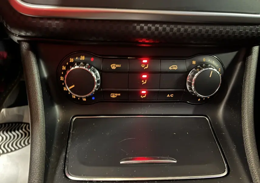 Gros plan sur la commande de climatisation noire de la Mercedes Classe A 180 CDI Sensation 2018, avec voyants rouges allumés.