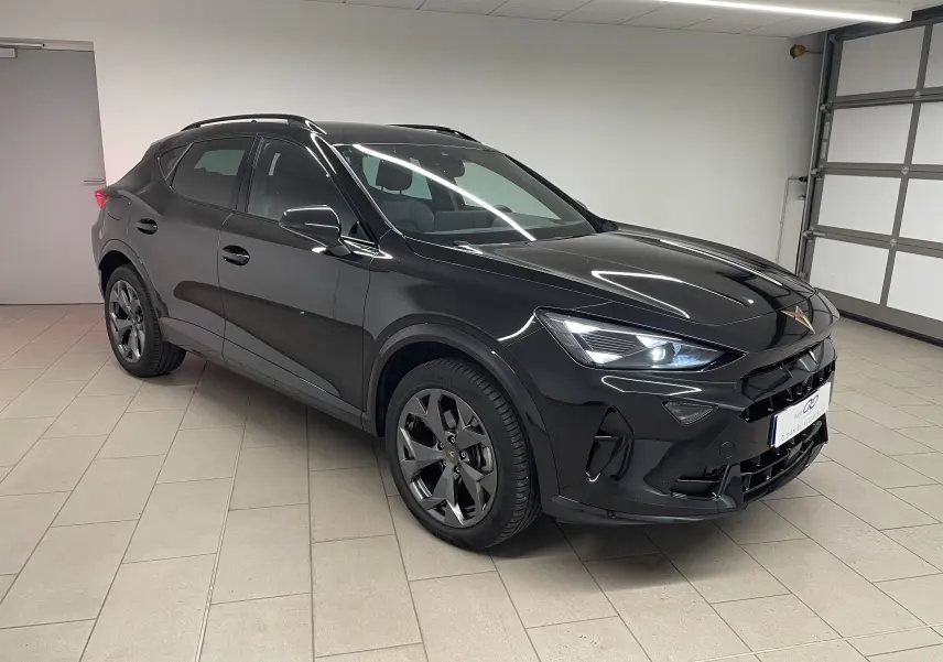 SUV CUPRA Formentor noir minuit vu en 3/4 avant droit dans un garage, avec phares allumés et jantes foncées.