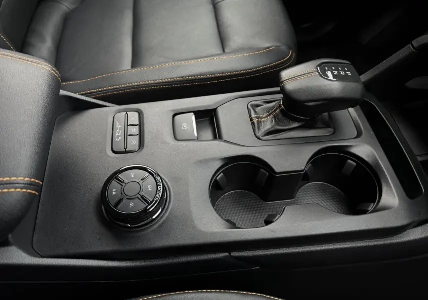 Gros plan sur la console centrale noire du Ford Ranger 2025 avec levier de vitesse automatique et molette de modes de conduite.