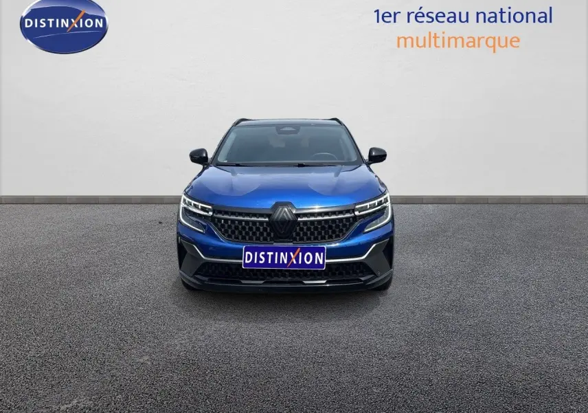 Vue frontale d'un Renault Austral E-Tech hybride bleu Iron Metal avec toit noir, calandre et phares LED distinctifs.