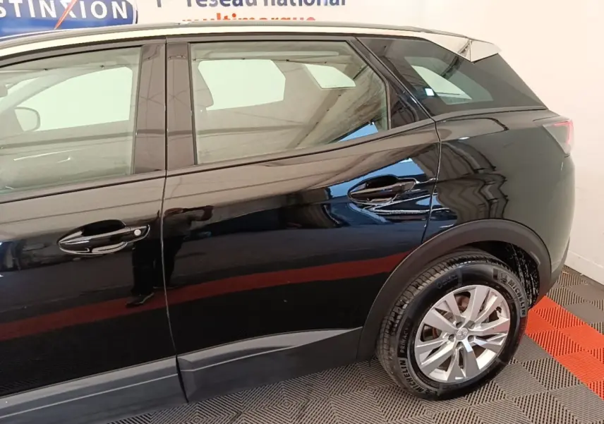 Vue latérale droite d'un Peugeot 3008 noir 2022 avec toit blanc et jantes alliage argentées.