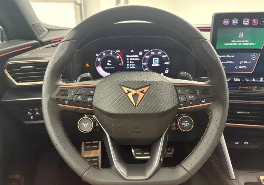 Vue rapprochée du volant perforé en cuir avec logo CUPRA cuivre et tableau de bord numérique du Formentor 2025.