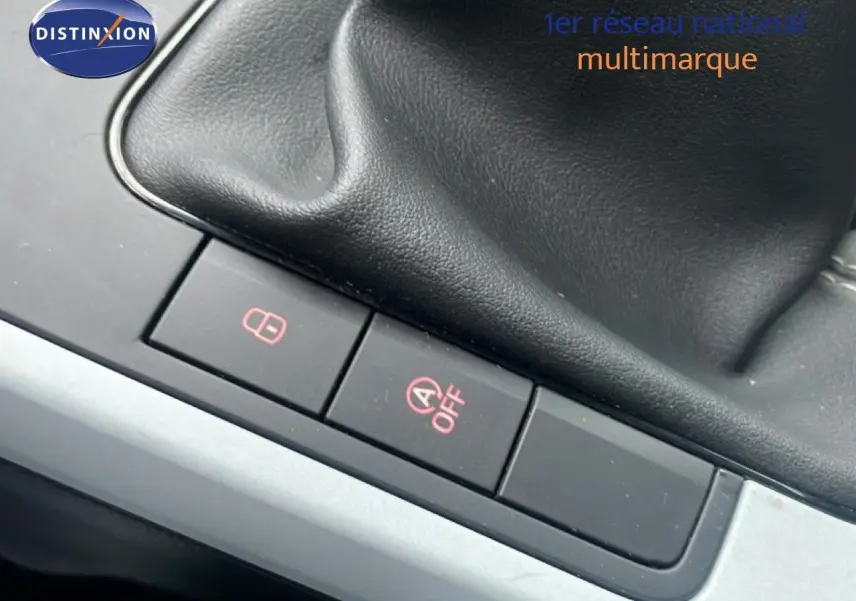 Gros plan sur les boutons de commande près du levier de vitesses d'une SEAT Arona blanche avec toit noir.