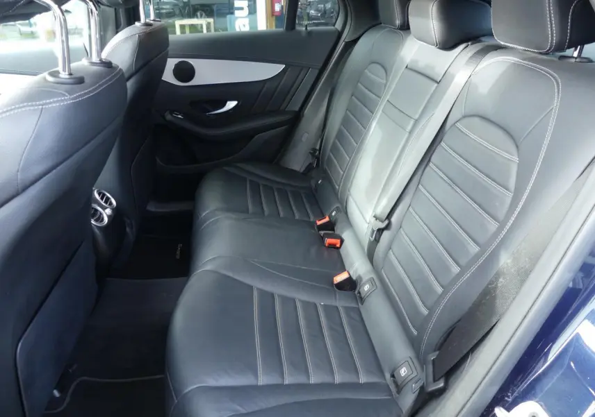 Vue intérieure des sièges arrière en cuir noir du Mercedes GLC Coupé 300 hybride bleu foncé, avec surpiqûres contrastées.