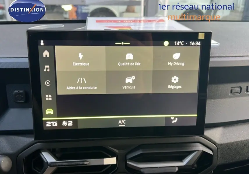 Vue intérieure centrée sur l'écran tactile du tableau de bord du Dacia Duster Hybrid 140 Journey 2025.