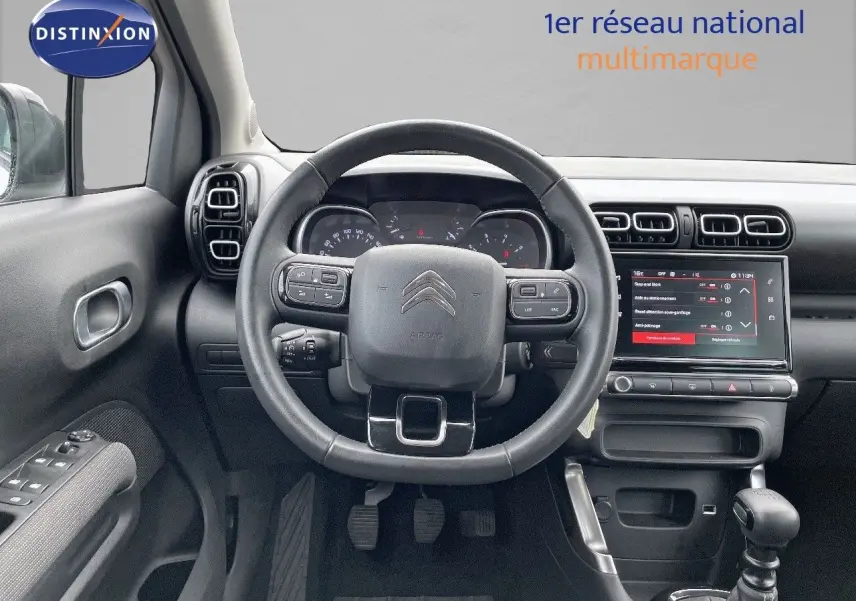 Vue centrée sur le volant et le tableau de bord du Citroën C3 Aircross 2023 avec écran tactile et commandes au volant.