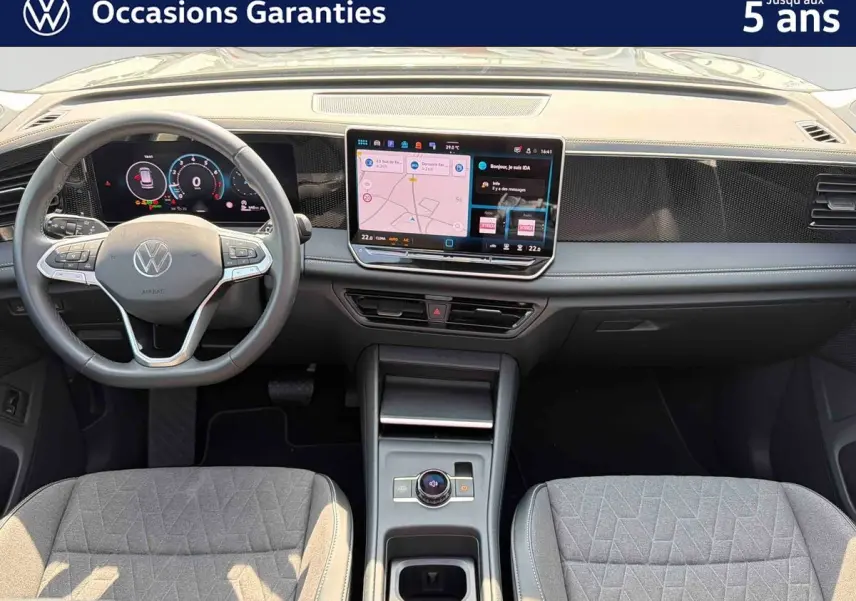Vue intérieure frontale du Volkswagen Tiguan 2025 gris, avec tableau de bord digital et écran tactile central.
