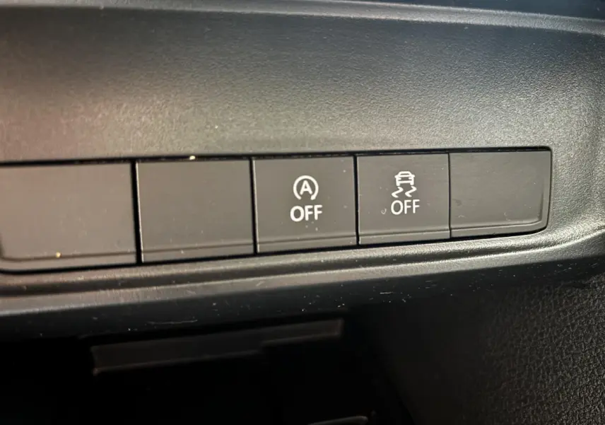 Gros plan sur les boutons de désactivation du système start-stop et de l'antipatinage du Volkswagen Caddy gris foncé 2019.