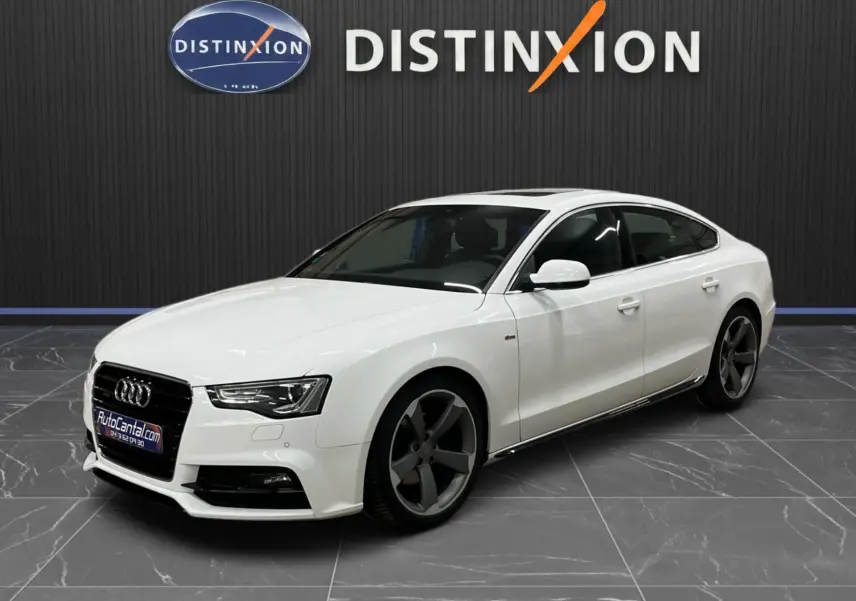 Audi A5 Sportback blanc vue 3/4 avant droit, avec jantes 5 branches foncées et calandre noire distinctive.