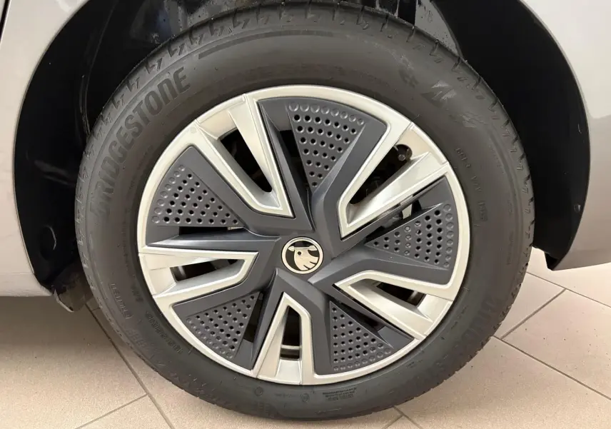 Gros plan sur la roue avant droite d'une Skoda Fabia 2023 gris graphite avec jante alliage au design moderne.