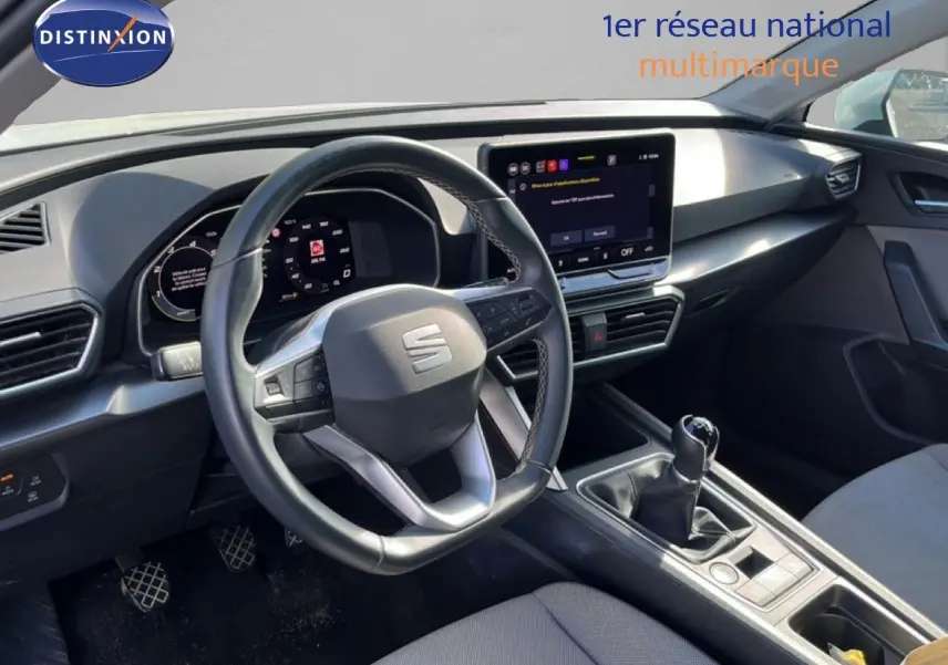 Vue intérieure côté conducteur du tableau de bord et levier de vitesse manuel d'une SEAT LEON blanc neige 2025.