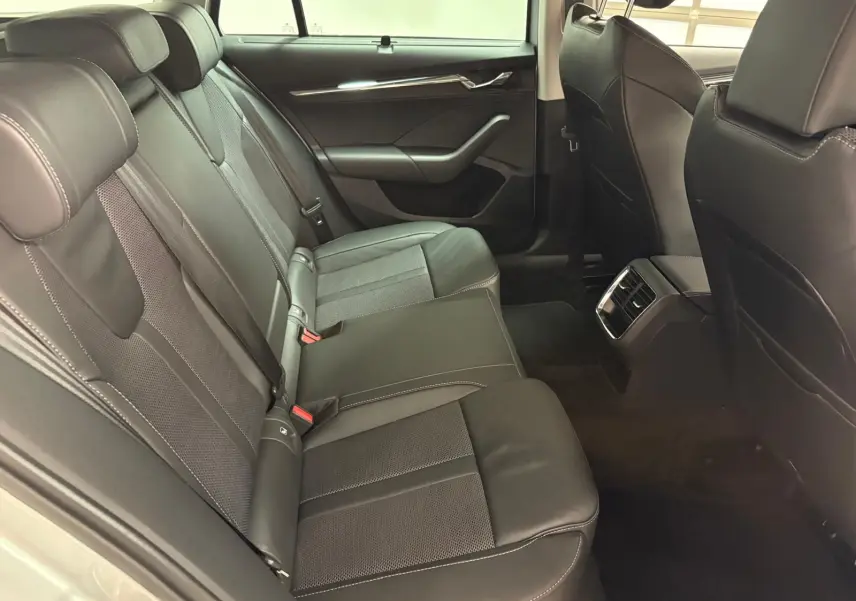 Vue intérieure arrière droite des sièges en cuir noir de la Skoda Octavia Combi gris argent 2023, version Style.