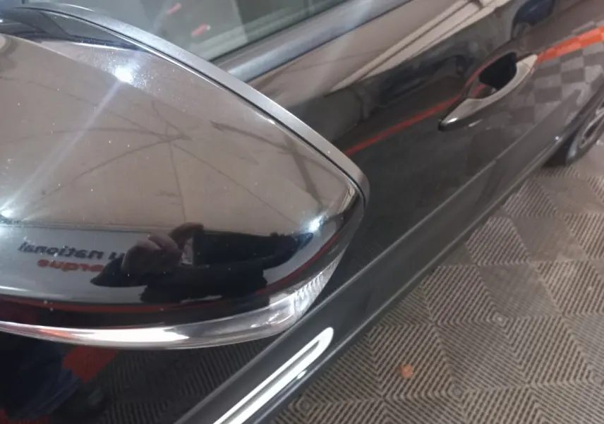 Rétroviseur droit noir brillant avec clignotant intégré sur la porte avant droite d'une Citroën C3 noire 2024.