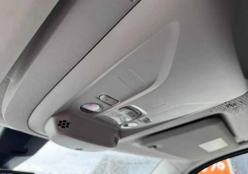 Plafonnier intérieur gris clair du Citroën Berlingo 2019 avec commandes d'éclairage et pare-soleil côté conducteur visible