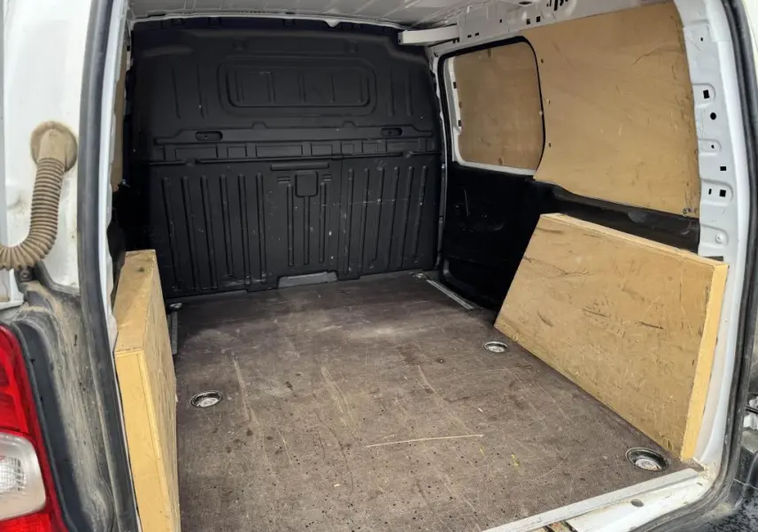 Vue intérieure arrière du Citroën Berlingo blanc 2019, montrant l'espace de chargement avec panneaux en bois et anneaux d'arrimage.