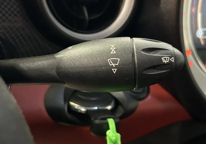 Gros plan sur la commande des feux et clignotants dans l'habitacle rouge d'une MINI Cabriolet Cooper S 2012.