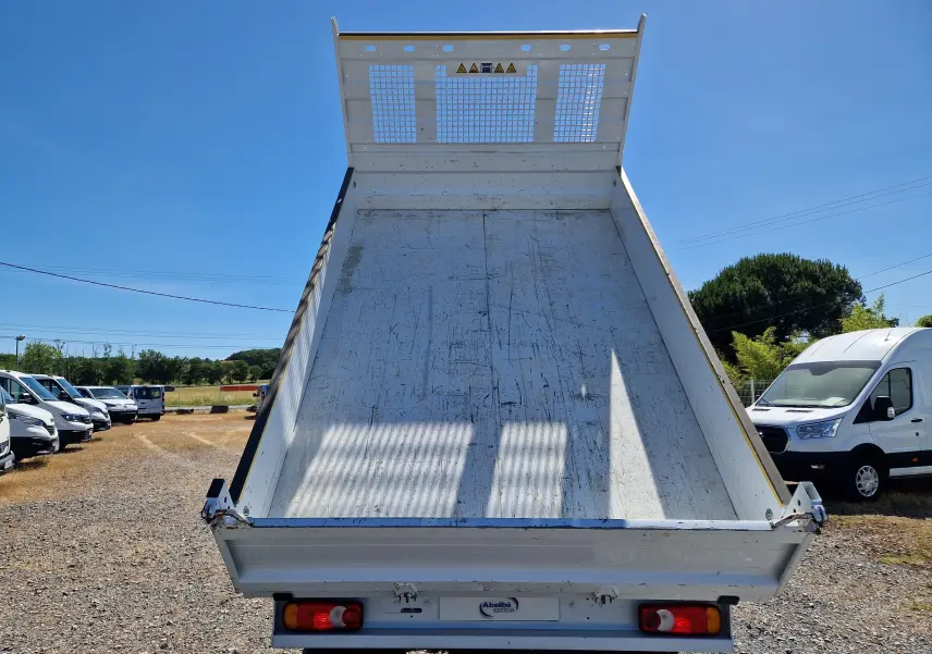 Vue arrière d’une benne relevée blanche sur un Renault Master Châssis Cabine 2024 avec roues jumelées.