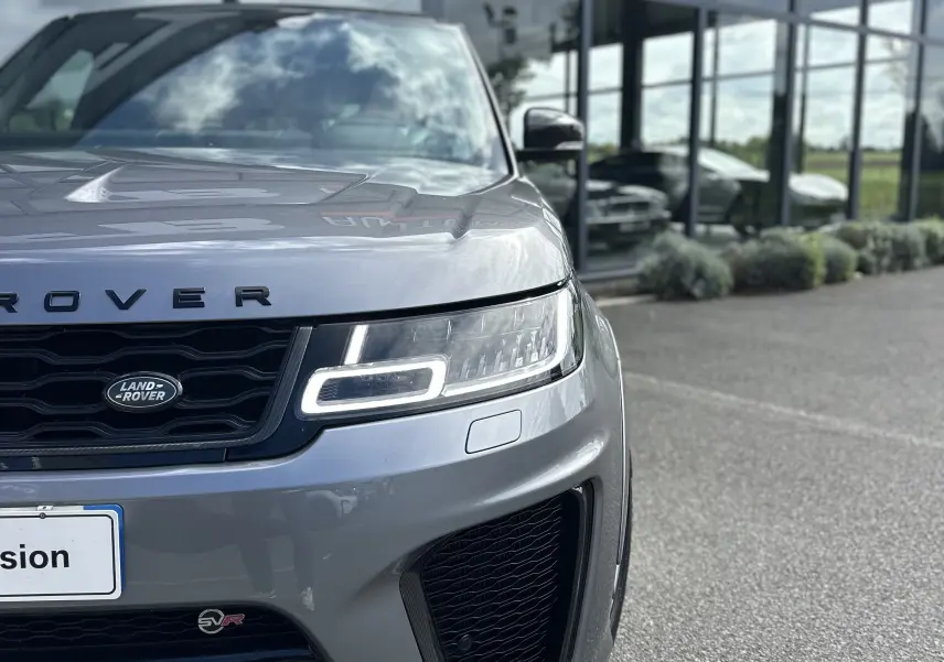 Vue de face droite d'un Range Rover Sport SVR Carbon Edition gris foncé avec phares LED et calandre noire.