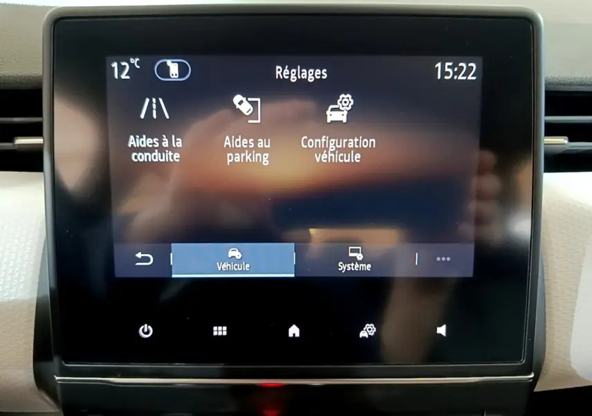 Écran tactile central de la Renault Clio gris foncé 2022 affichant les réglages d’aides à la conduite et au parking.
