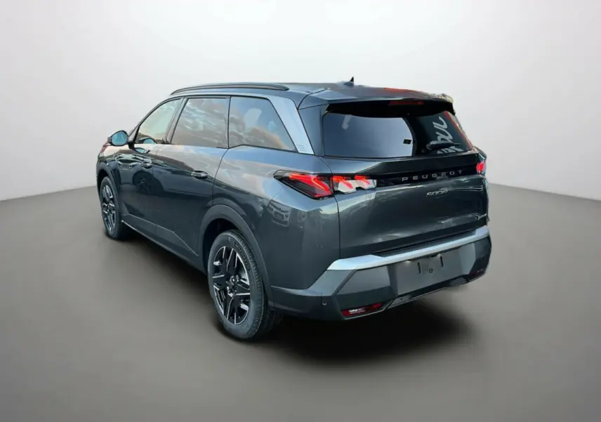 Vue 3/4 arrière droite d’un Peugeot 5008 Hybrid 145 GT gris titane avec toit noir et jantes alu 19 pouces.