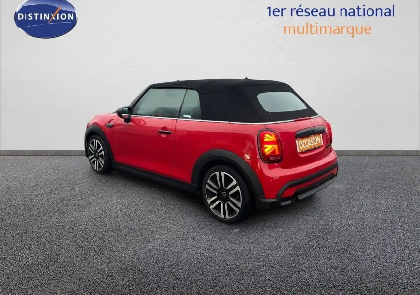 Vue 3/4 arrière droite d'une MINI Cabriolet F57 rouge chili avec capote noire et feux arrière à motif Union Jack.