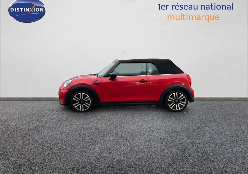 Profil côté gauche d'une MINI Cabriolet F57 rouge chili avec toit noir fermé sur fond neutre.