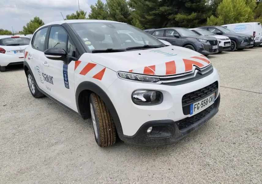 Citroën C3 Société blanche vue 3/4 avant droit avec marquages orange et logo Saur sur porte avant.