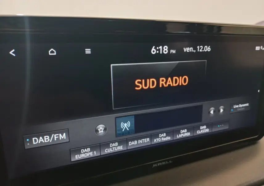 Écran tactile central du Hyundai Santa Fe gris clair affichant la radio DAB/FM en intérieur véhicule.