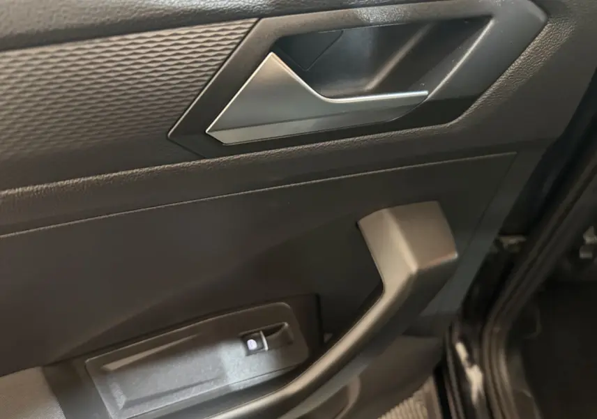 Détail de la porte avant gauche noire du Volkswagen T-Roc 2020 avec poignée argentée et commande de verrouillage.