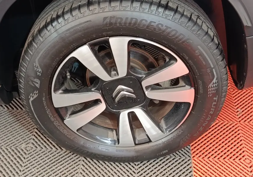Gros plan sur la roue avant droite du Citroën C3 Aircross beige, avec jante alliage et logo Citroën au centre.