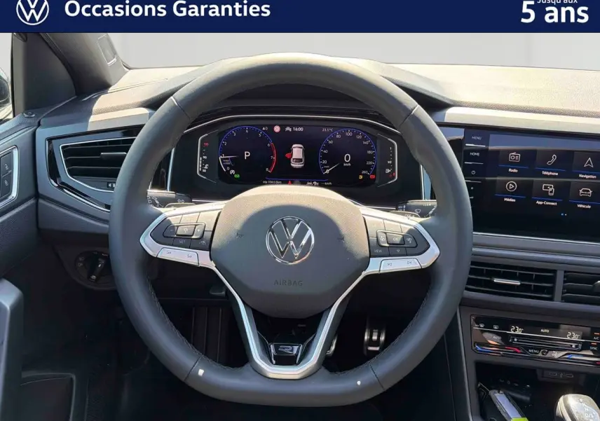 Vue intérieure centrée sur le volant cuir multifonctions du Volkswagen Taigo 1.5 TSI 150 DSG7 avec tableau de bord digital.