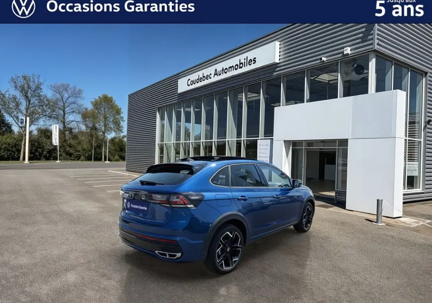 Volkswagen Taigo bleu métallisé en 3/4 arrière droit, avec jantes alliage noires et toit ouvrant électrique.
