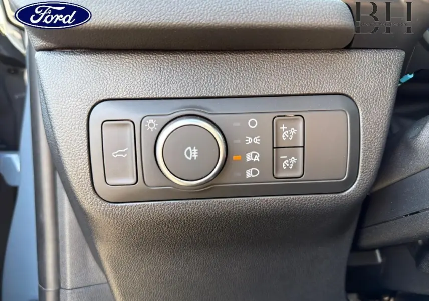Gros plan sur la commande d’éclairage noire à gauche du tableau de bord du Ford Kuga bleu 2026.