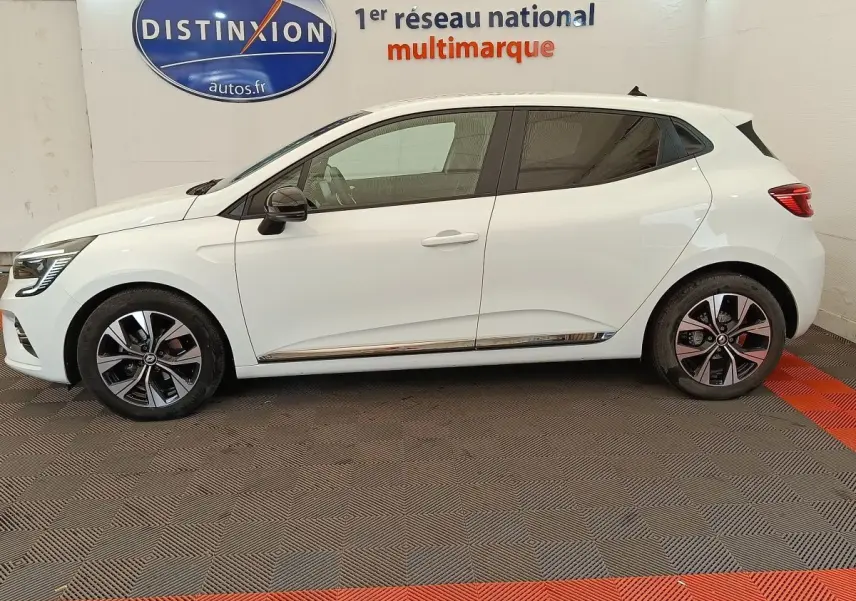 Profil droit d'une Renault Clio blanche Evolution TCe 100 GPL 2023 avec jantes alliage et rétroviseurs noirs.