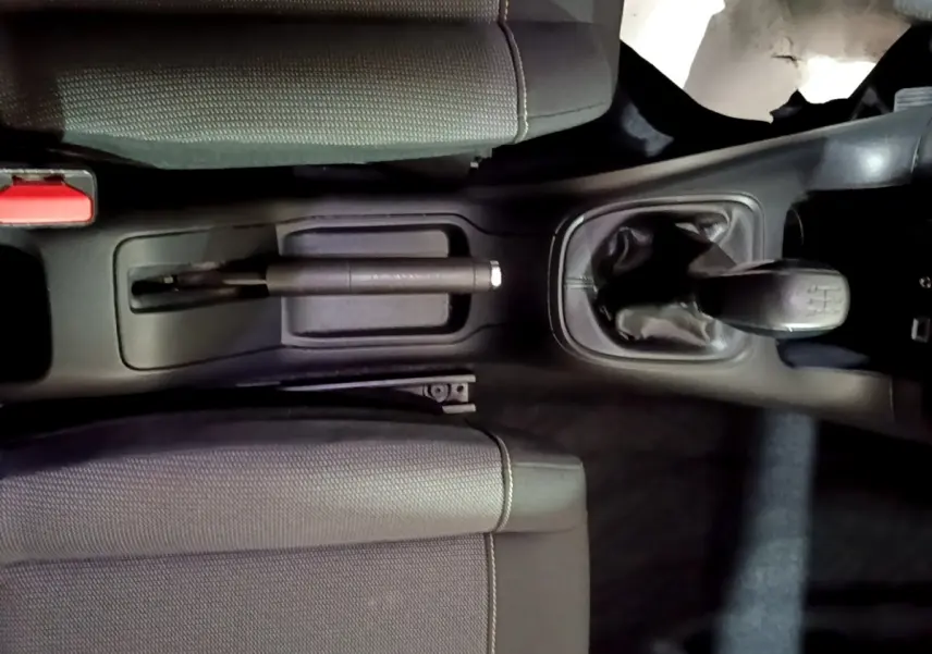 Vue plongeante sur la console centrale noire et la boîte manuelle de la Citroën C3 BlueHDi 2017 avec sièges gris.