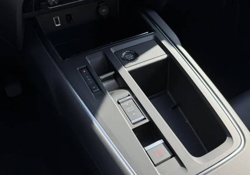 Vue rapprochée de la console centrale noire du Citroën C5 Aircross 2025 avec bouton start/stop et sélecteur de mode de conduite.