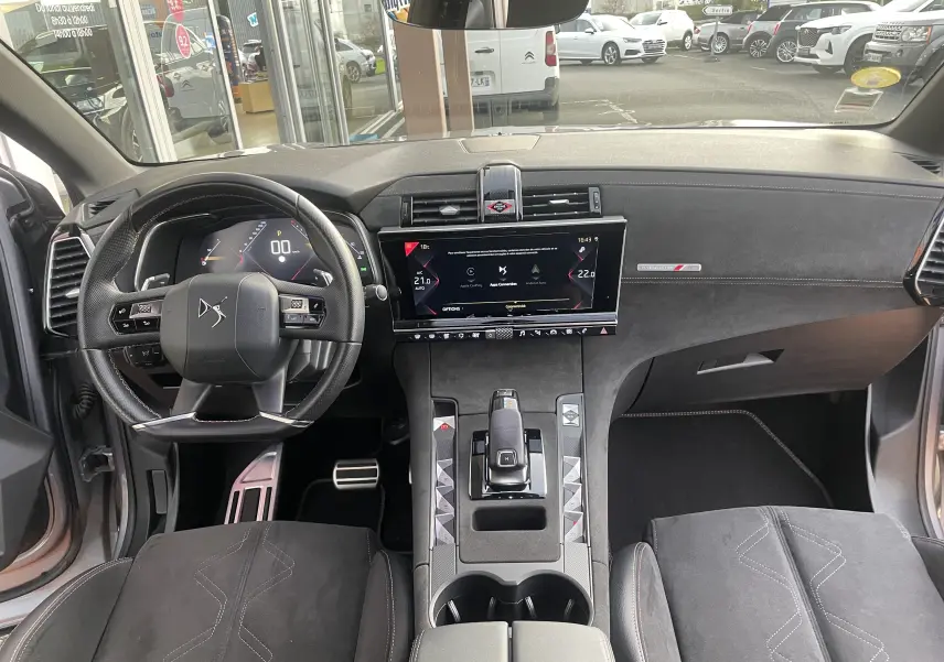 Vue intérieure avant du DS7 1.5 BLUEHDi 130 EAT8 PERFORMANCE LINE avec tableau de bord noir et volant multifonction.