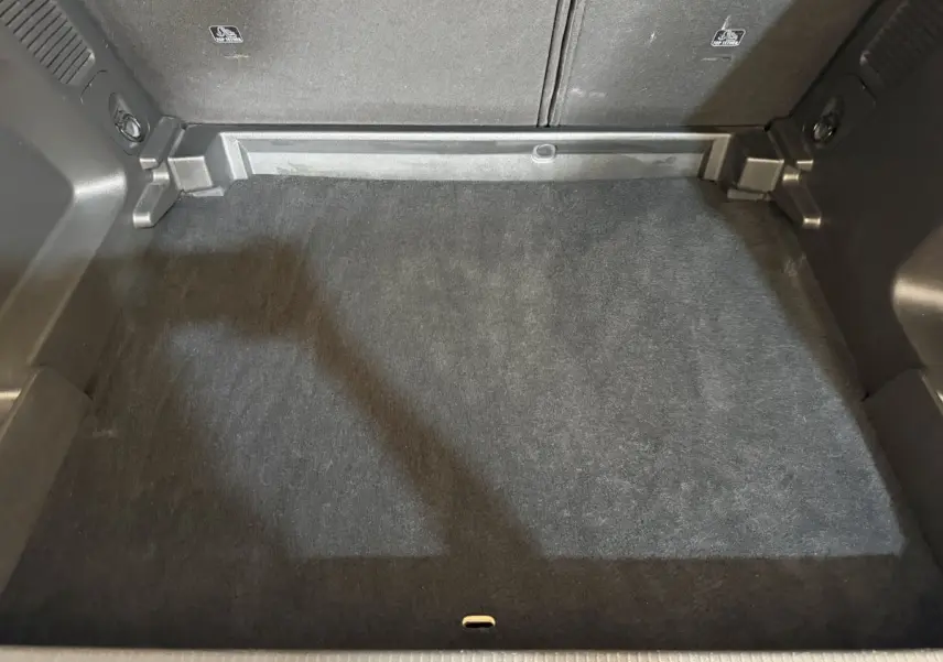 Vue plongeante sur le coffre noir spacieux et propre de l’Opel Grandland X 1.5 Diesel 130 Elegance Business.