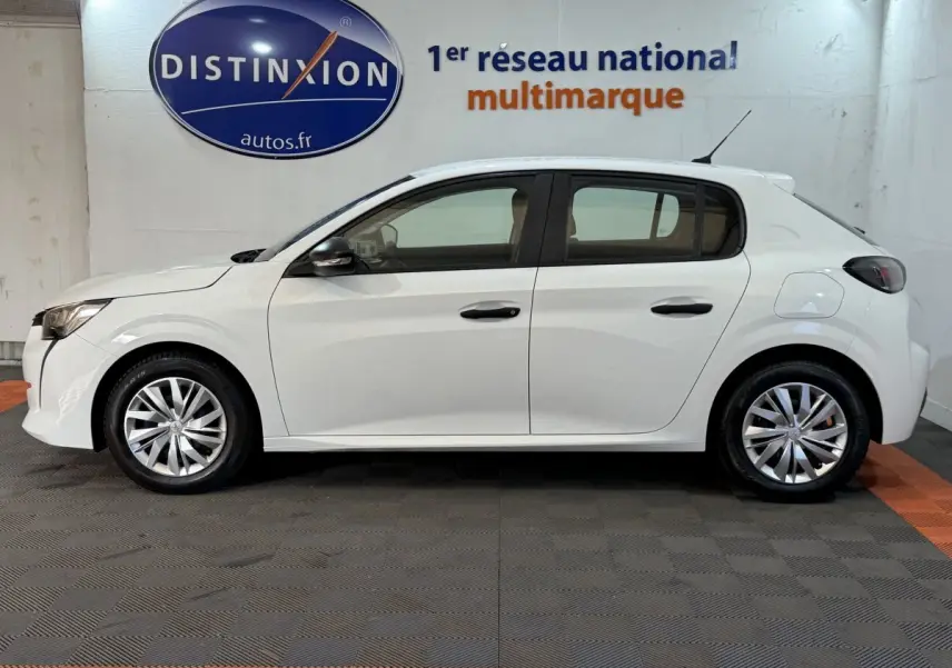 Vue de profil côté gauche d’une Peugeot 208 PureTech 75 S&S Like blanche, avec jantes alliage et antenne de toit.