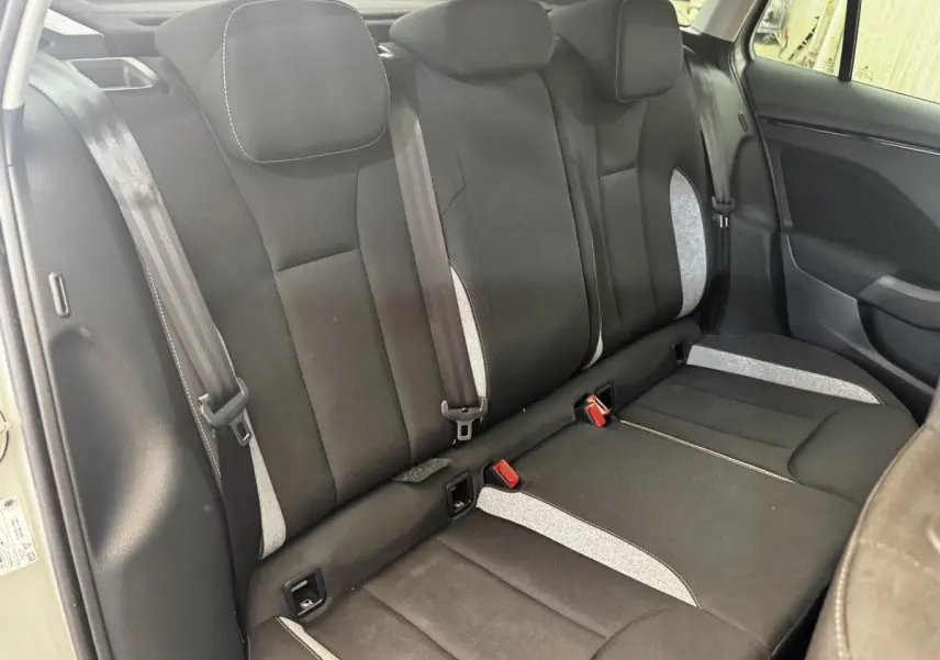 Vue intérieure sur la banquette arrière noire et grise de la Skoda Scala 2025, côté droit avec ceintures visibles.
