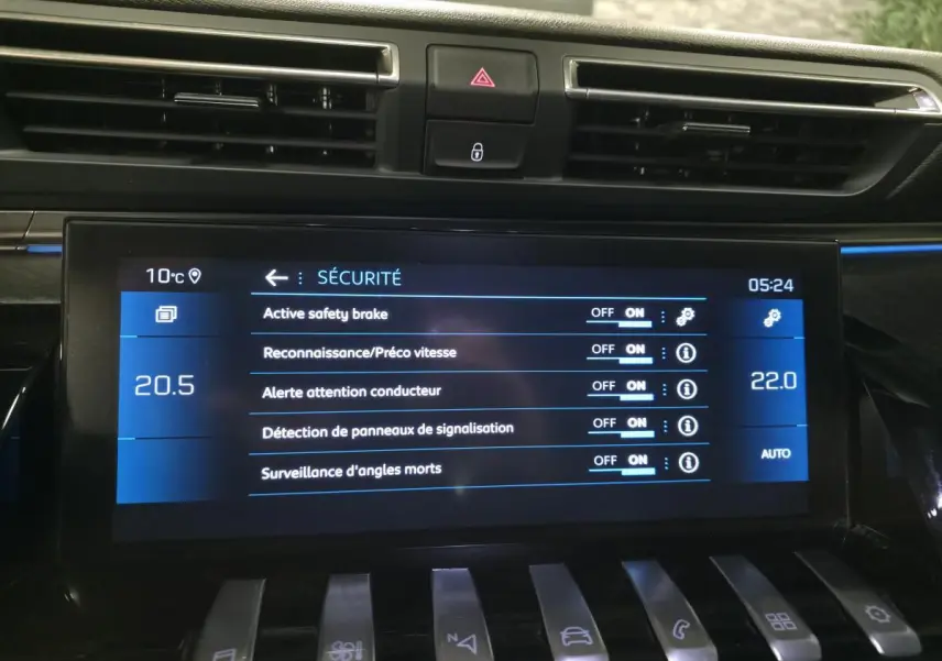 Écran tactile central de la Peugeot 508 gris montrant les réglages de sécurité avec commandes piano en bas.