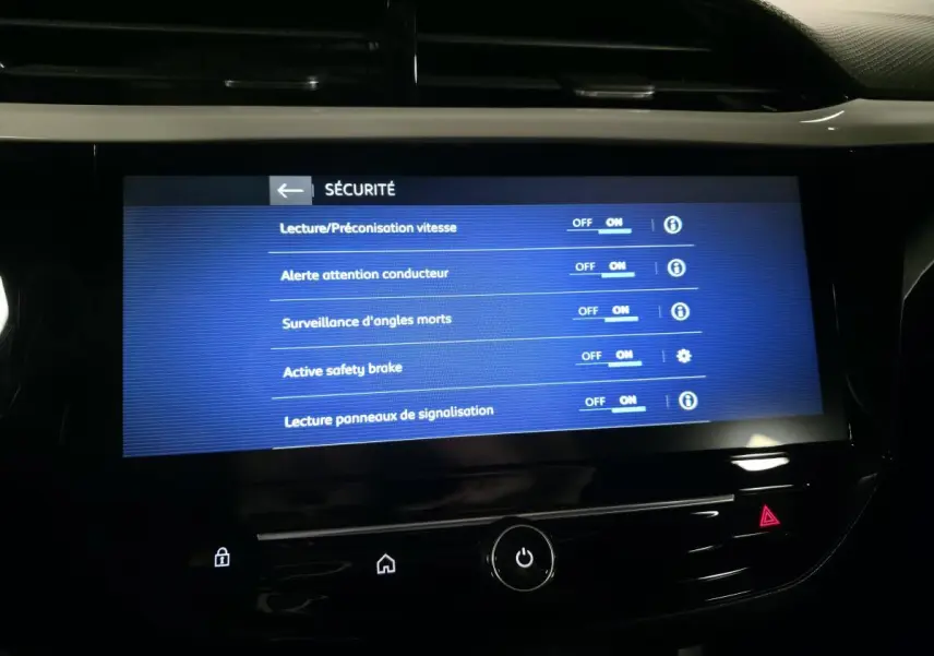 Écran tactile central de l’Opel Corsa 2024 affichant les réglages de sécurité avec fond noir et texte blanc.