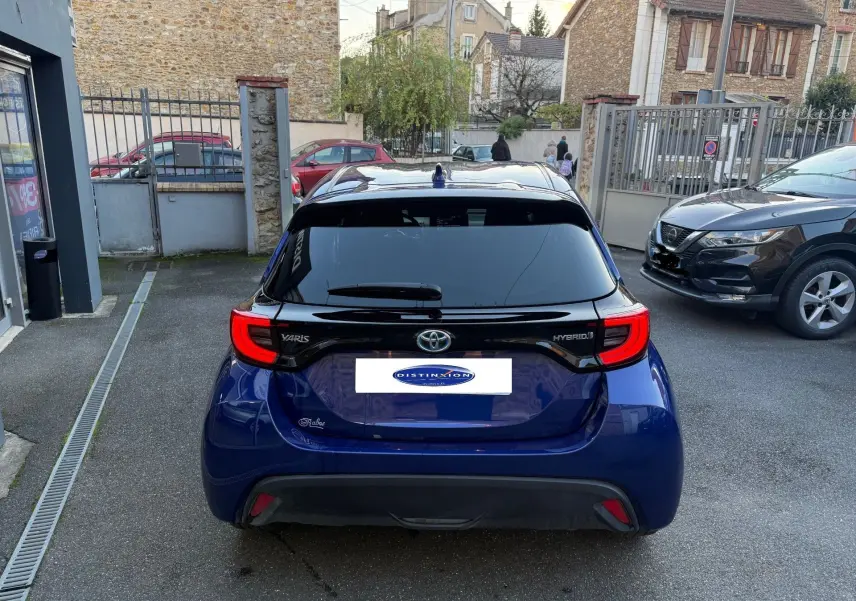 Vue arrière d'une Toyota Yaris Hybride bleu métal 2021 avec feux LED distinctifs et vitrage arrière teinté.