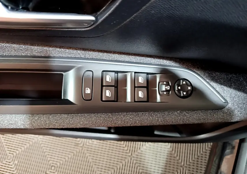 Vue rapprochée des commandes de lève-vitres et rétroviseurs côté gauche d’une Peugeot 3008 noir 2022.